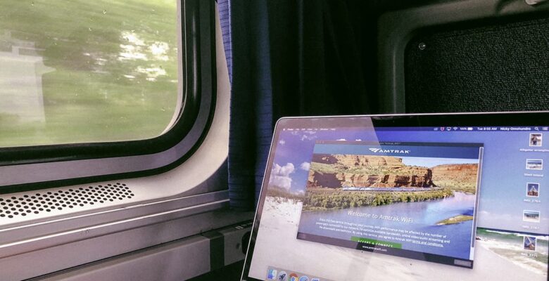 laptop with amtrak wifi displayed on screen next to a train window