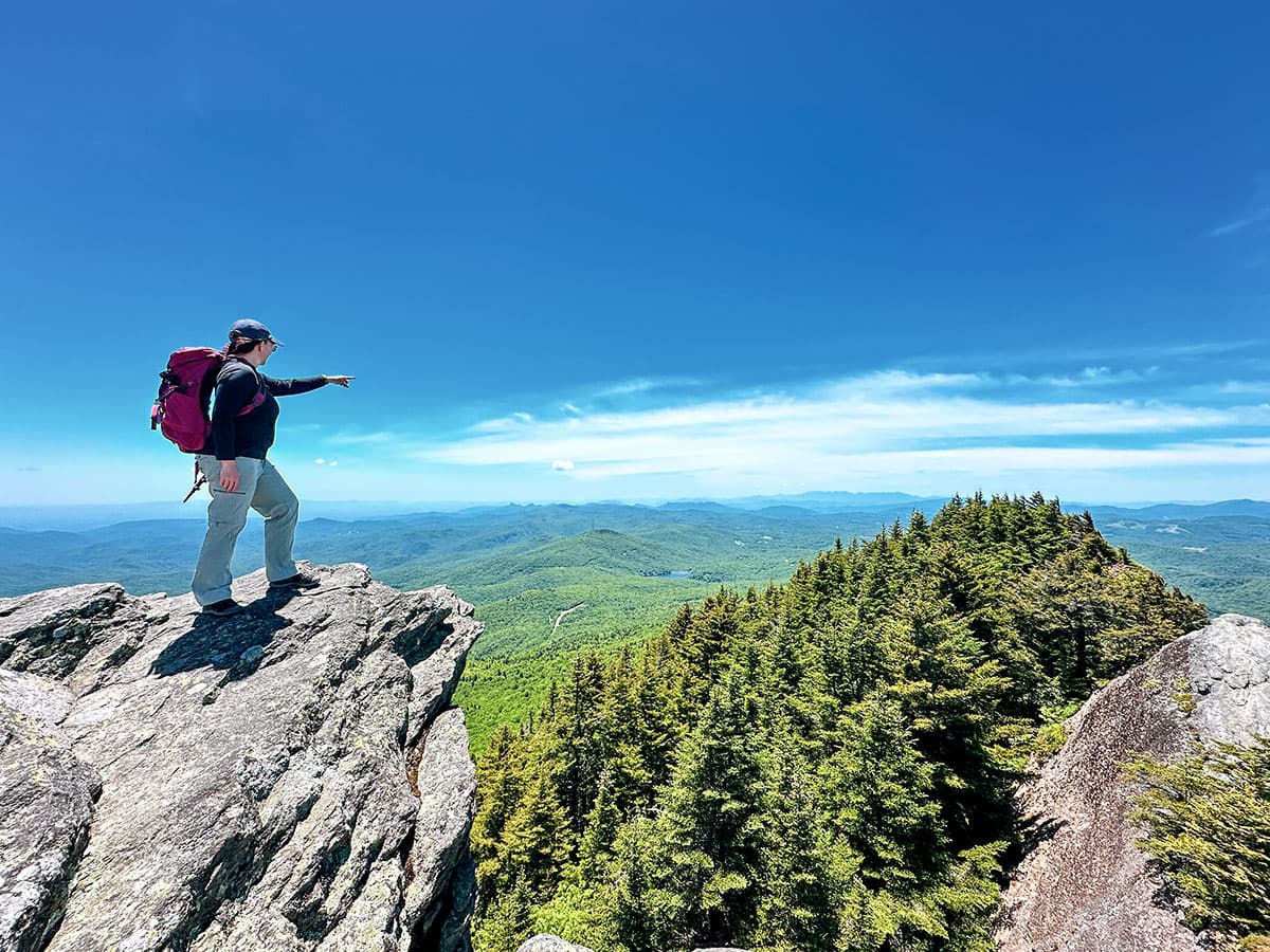 woman hiker standing atop a mountain vista