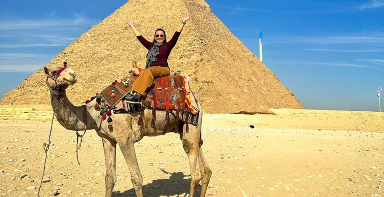 woman on on camel in front of Egyptian pyramid