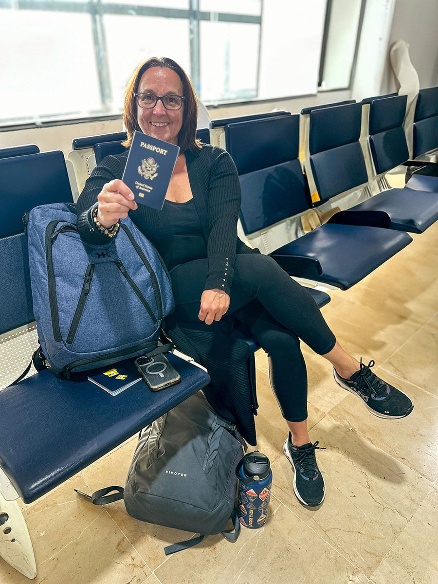 woman at an airport with passport in hand
