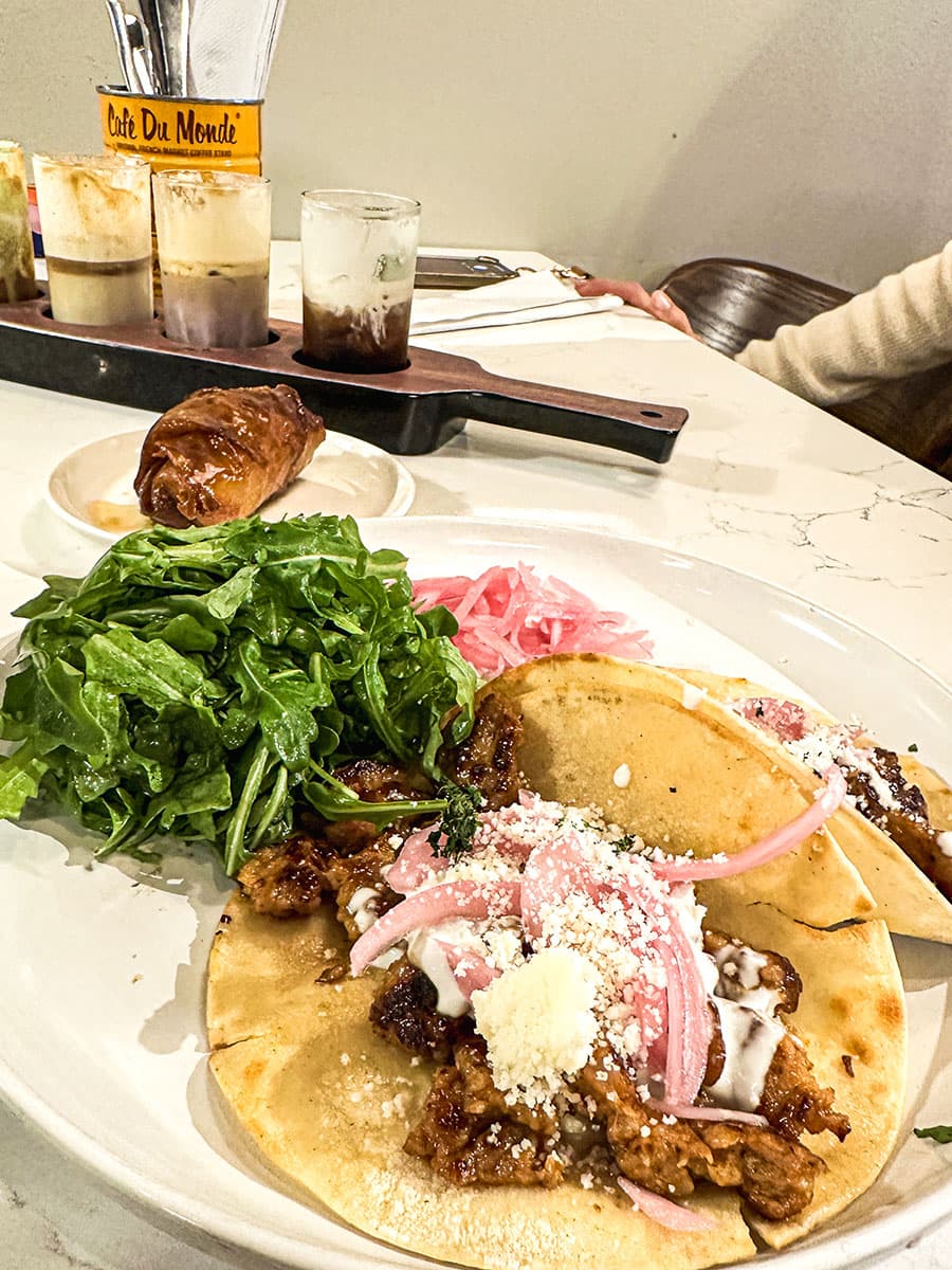 Breakfast tacos at Neighborhood Cafe and coffee flight in background