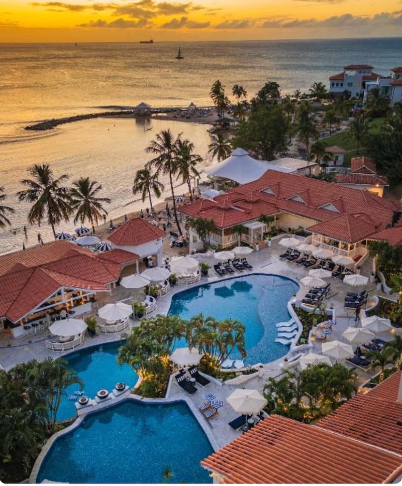 Windjammer Landing pool area with umbrellas and loungers at sunset